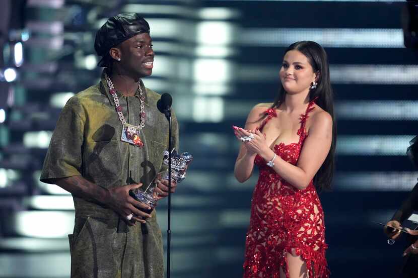 Rema, left, and Selena Gomez accept the award for best afrobeats for "Calm Down" during the...