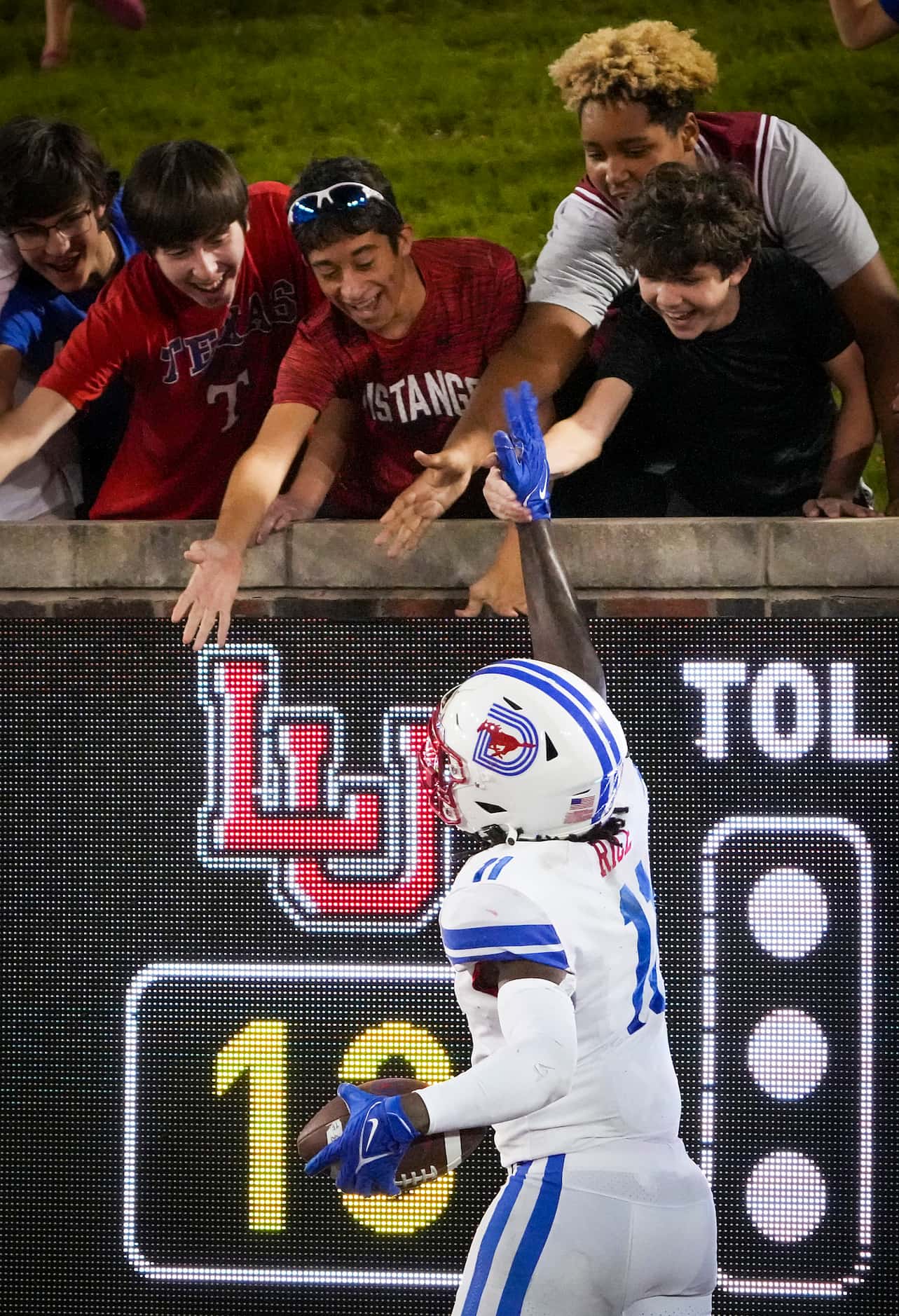 SMU wide receiver Rashee Rice (11) celebrates with fans after scoring on a touchdown pass...