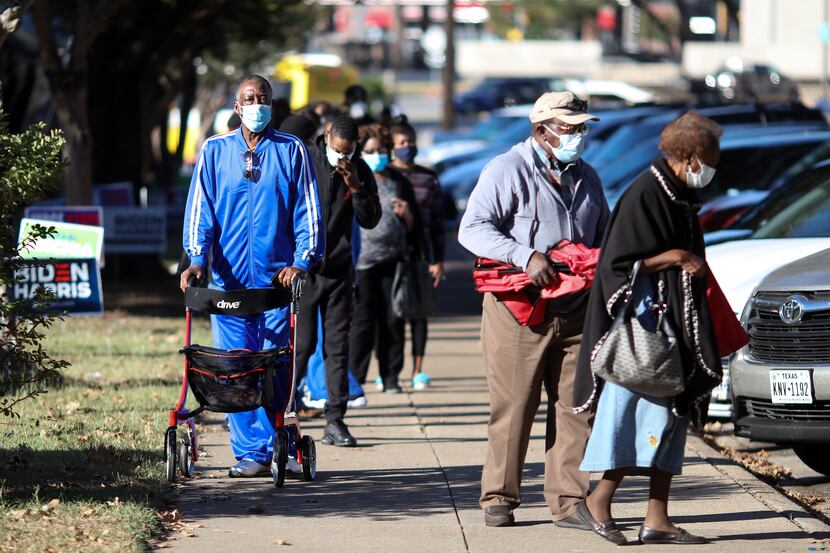 Voters in Oak Cliff wait to cast ballots on Oct. 13, the first day of early voting for the...