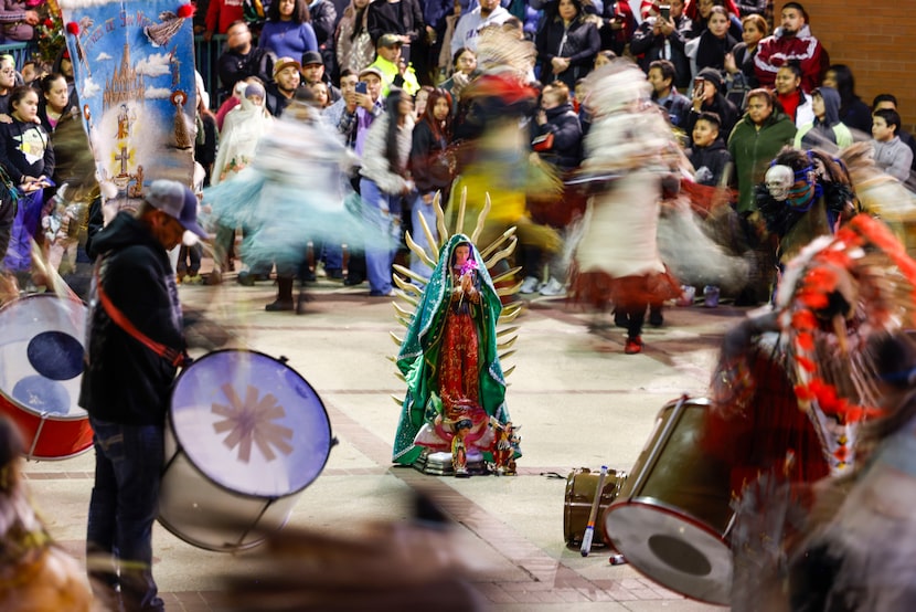 Matachines bailan rodeando una imagen de la Virgen afuera de la Catedral de Guadalupe el 12...