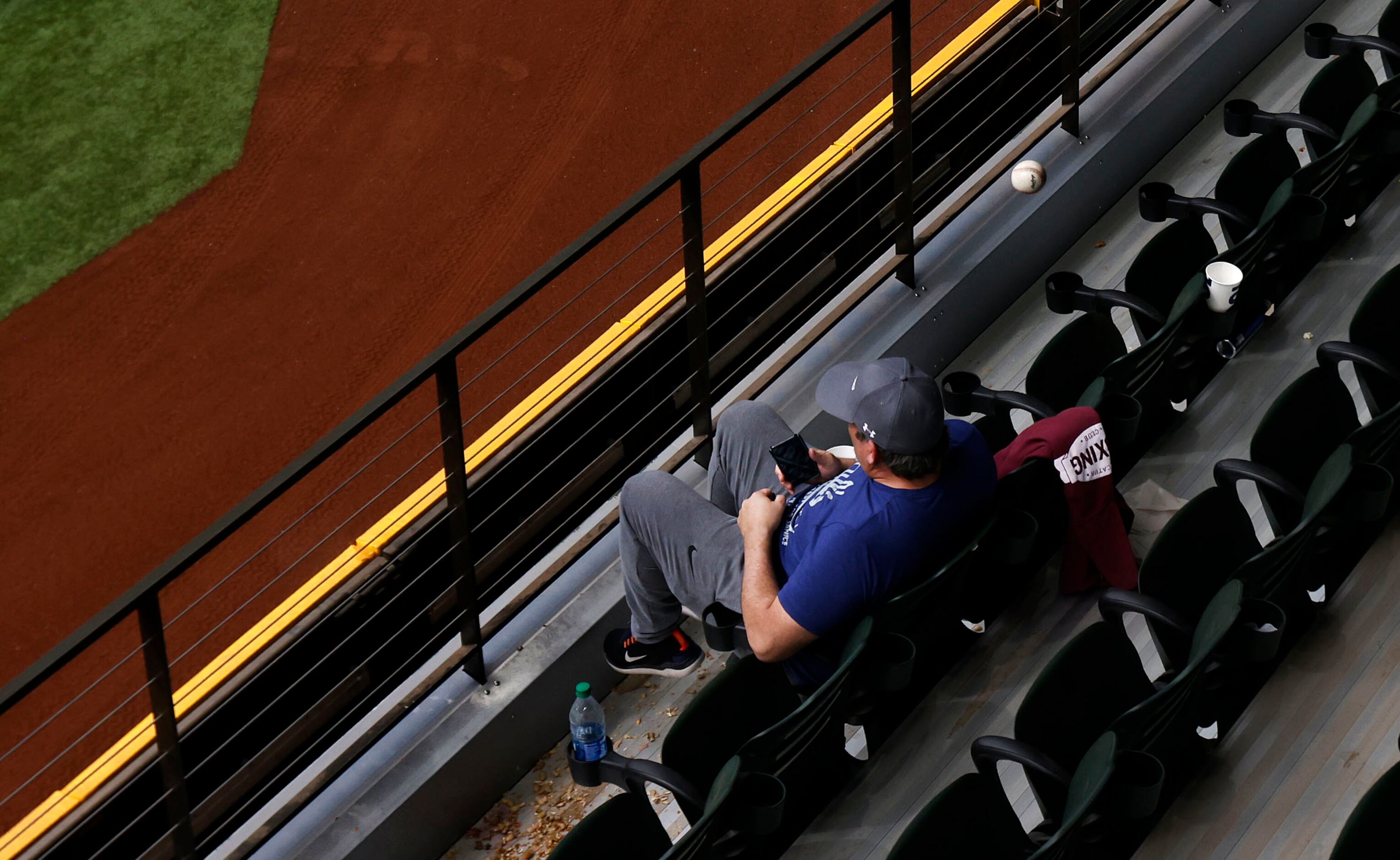 A home run ball off the bat of Texas Rangers batter Andy Ibáñez nearly hits a fan sitting in...