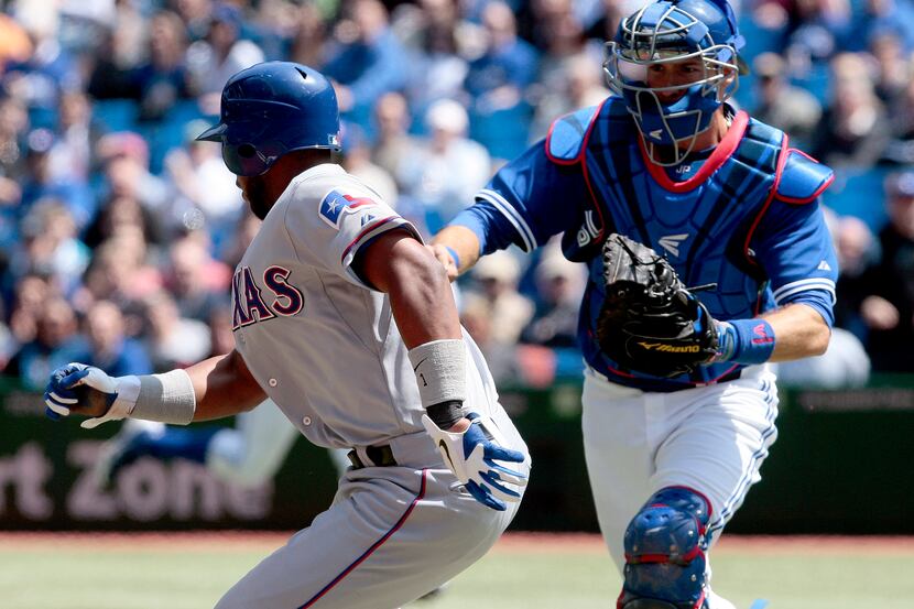 Elvis Andrus (1) of the Texas Rangers is tagged out in a run down at third base by J.P....