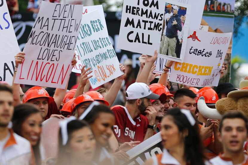 Fans hold up signs as ESPN College GameDay broadcasts from the State Fair of Texas prior to...