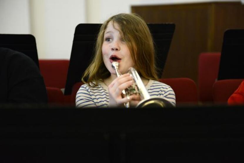 Band student Hannah Burn, 9, reacts to music instruction during the Salvation Army’s Dallas...