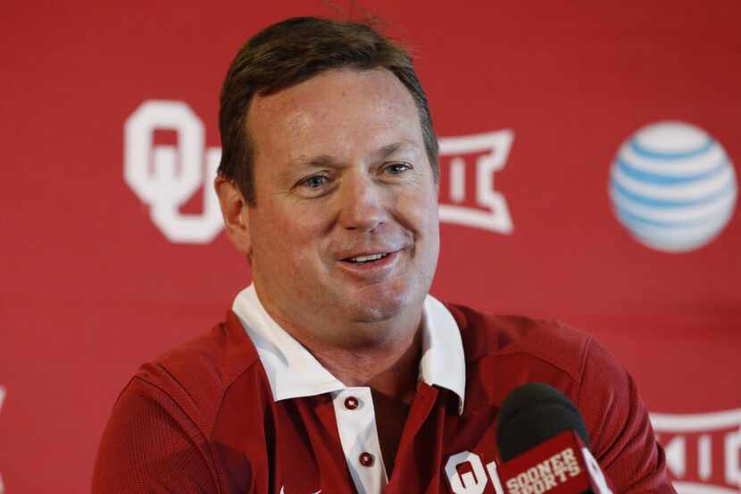 Oklahoma head coach Bob Stoops smiles as he answers a question during NCAA college football...