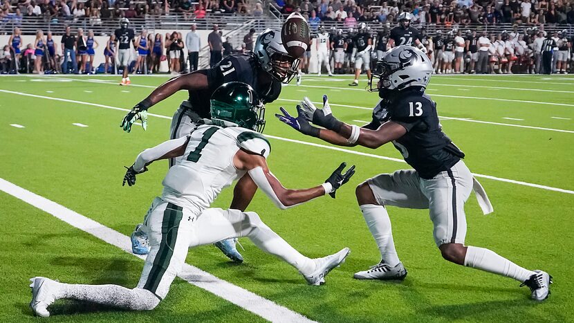 Denton Guyer defensive back Anthony Benford (13) reaches for a pass intended for Prosper...