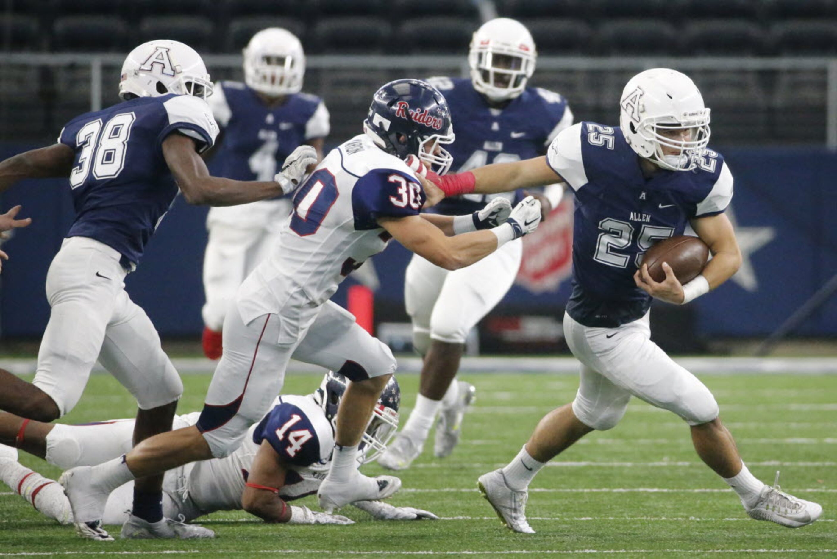 Allen's Ryan Bishop (25) runs with the ball after fielding an onside kick in the second...