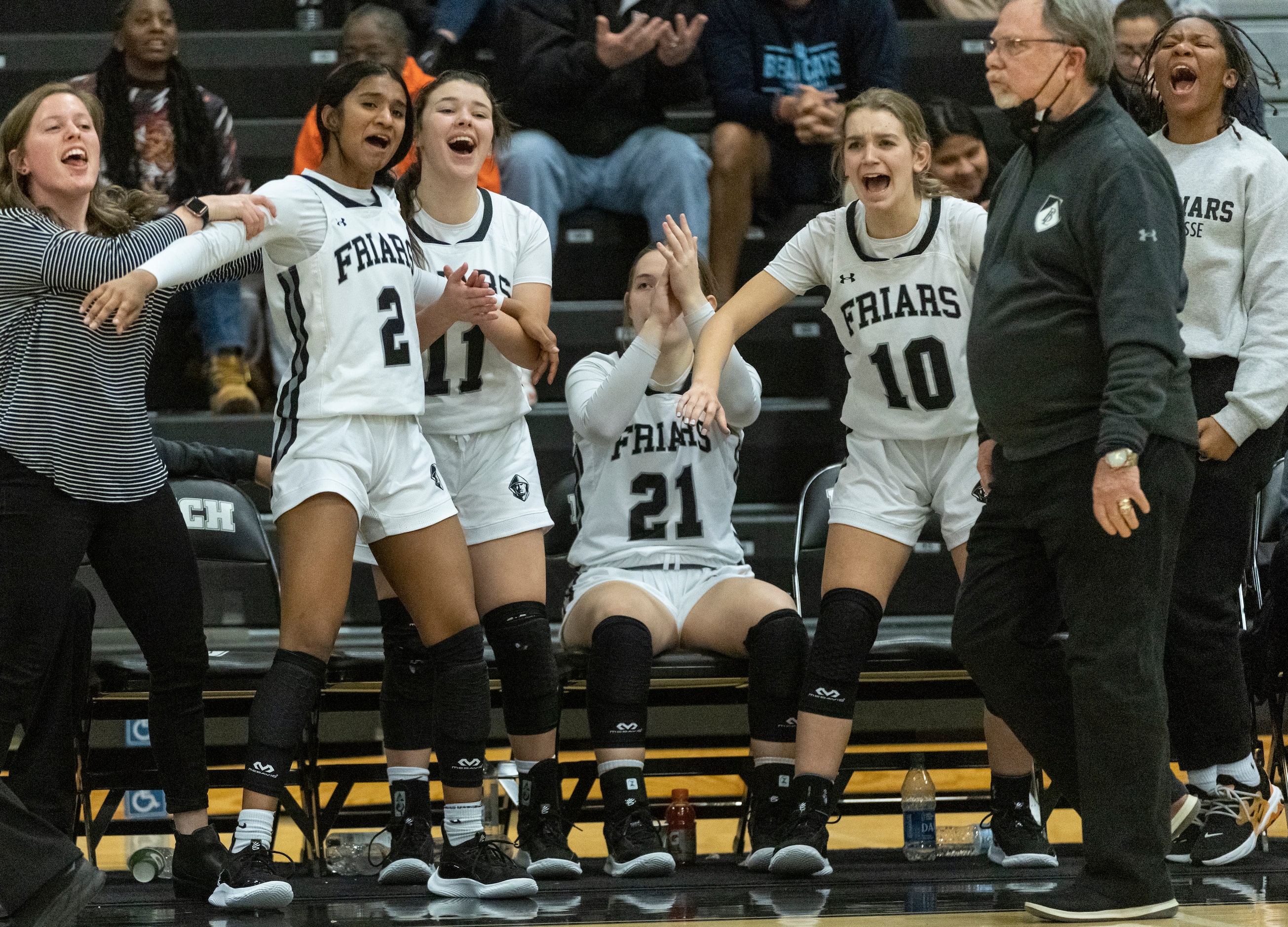 Bishop Lynch High School players celebrate as their teammates score in the fourth quarter...