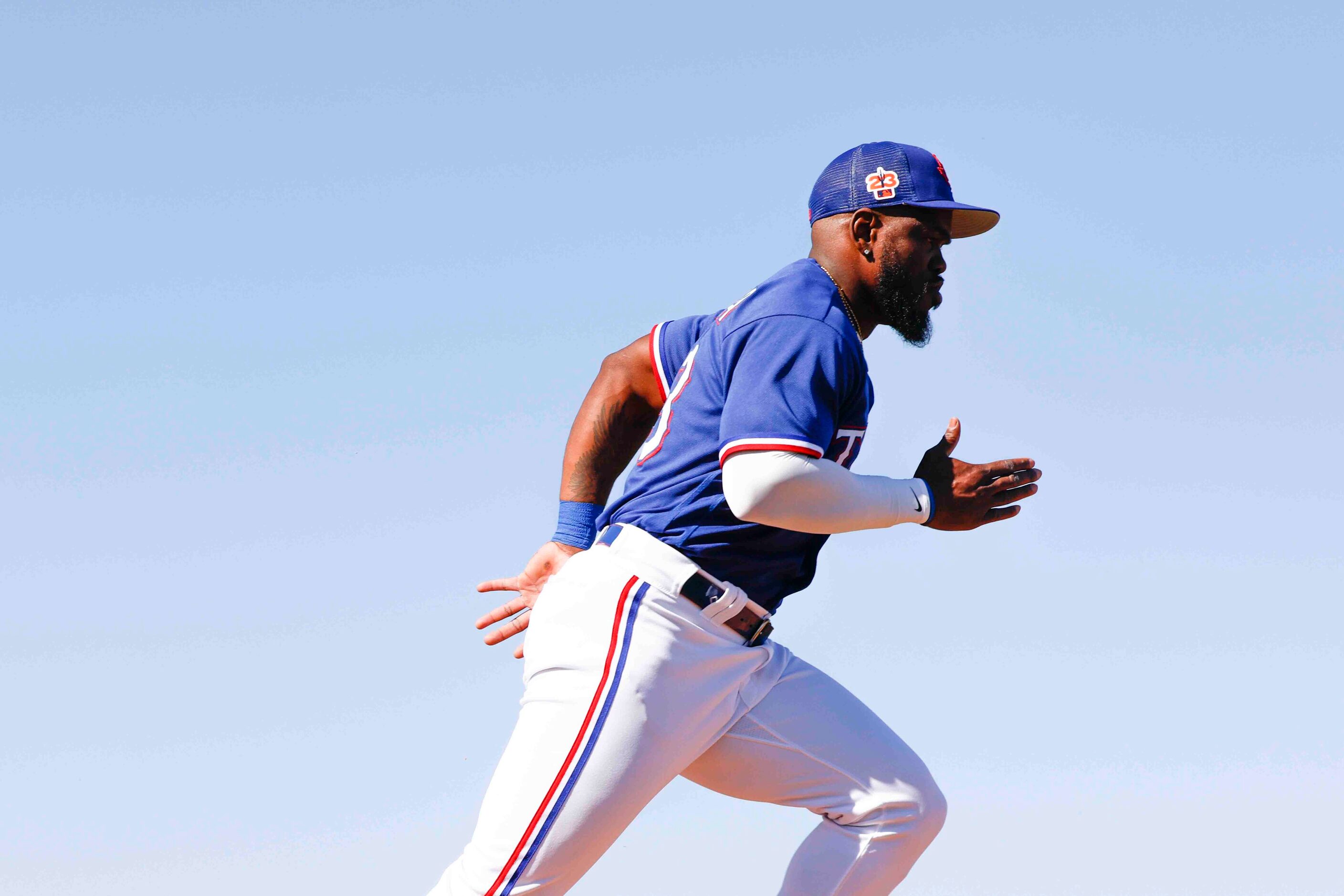 Texas Rangers outfielder Adolis Garcia runs during a drill at spring training workout at the...