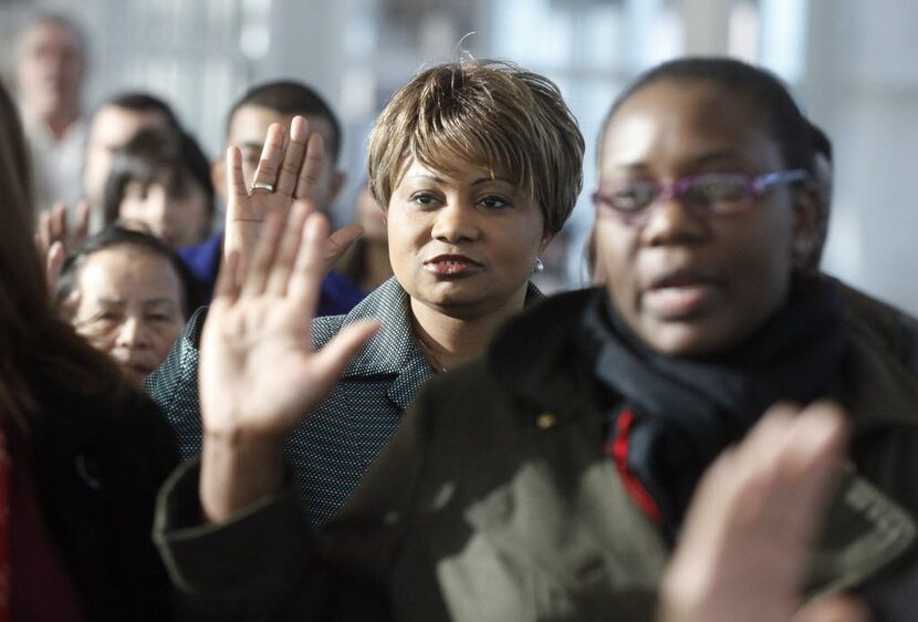 Ngozi Ikeogu of Nigeria, center, was one of 100 applicants from 34 countries sworn in as...