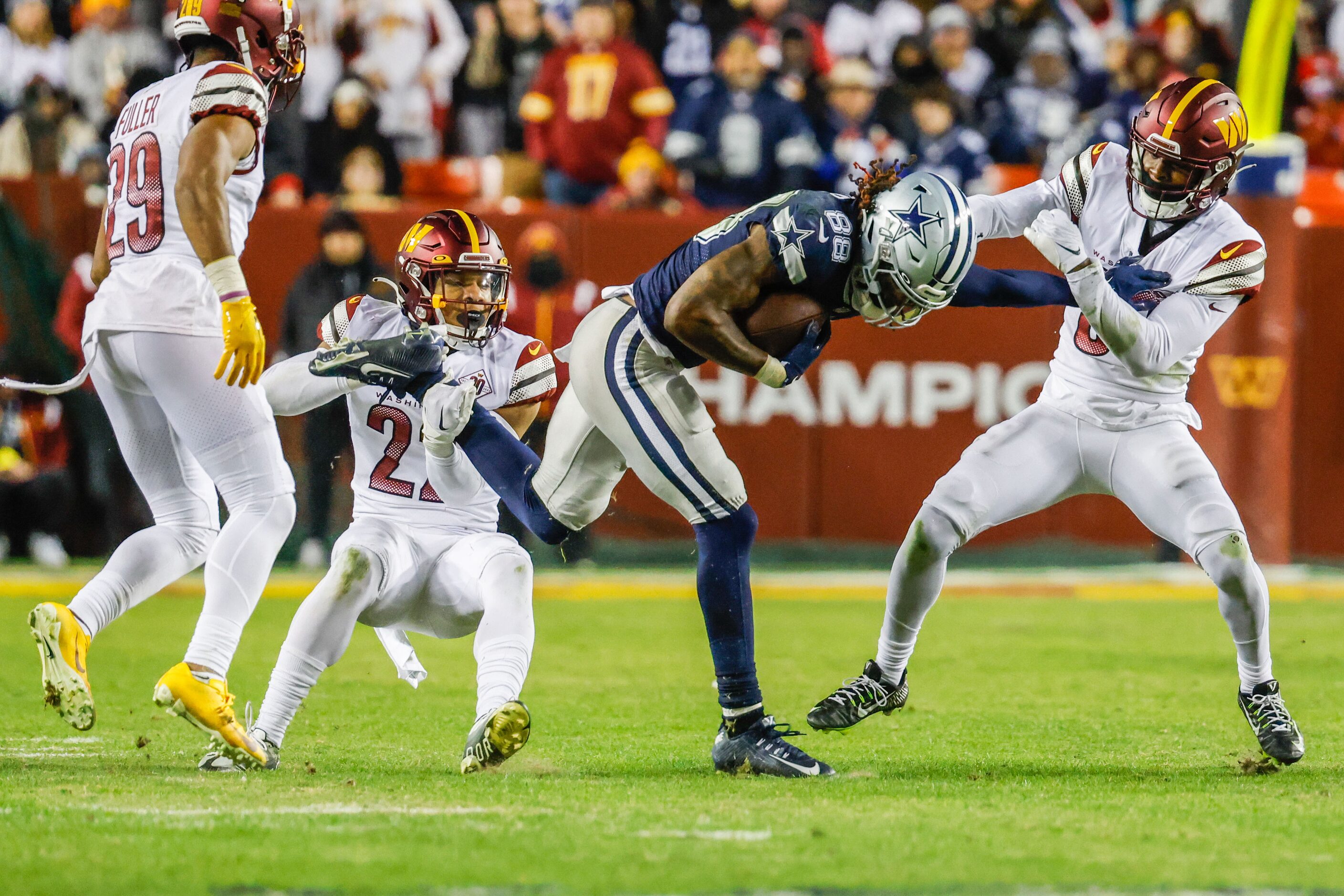 Dallas Cowboys wide receiver CeeDee Lamb (88) tries to get away from Washington Commanders...