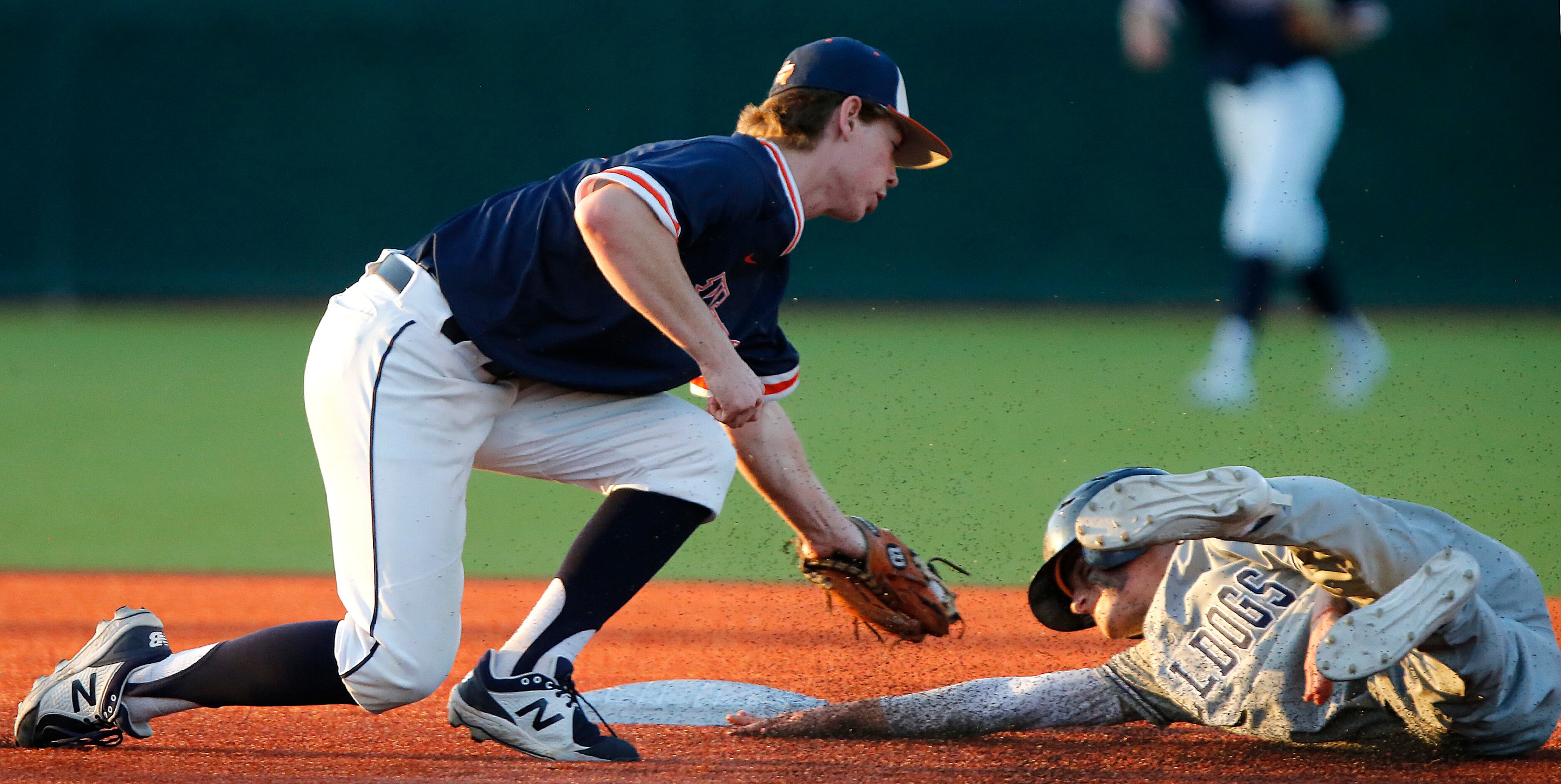 Wakeland High School shortstop Conor Linkfield (8) tags out McKinney North High School...