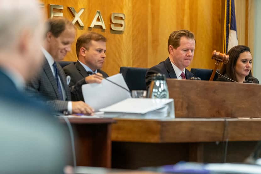 Public Utility Commission of Texas chairman Peter Lake, center, ends a commissioners meeting...