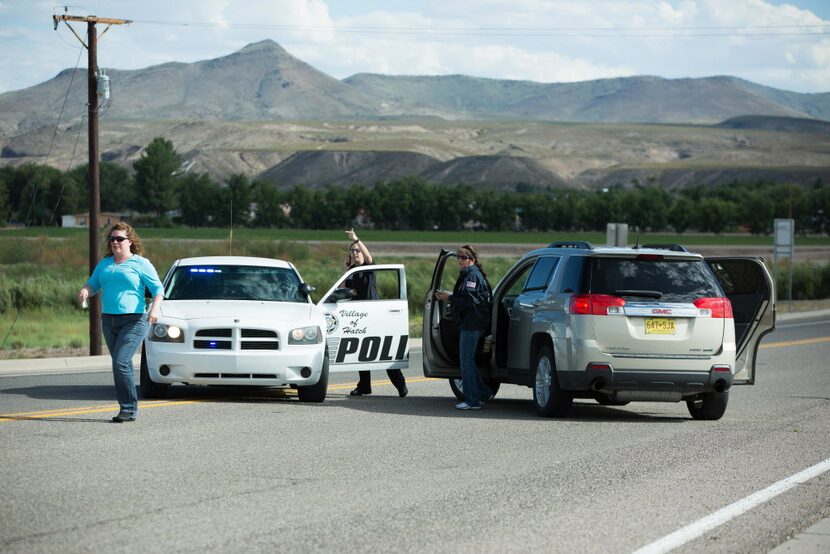 Police officers and state employees prevent drivers from entering Hatch, N.M., after a...