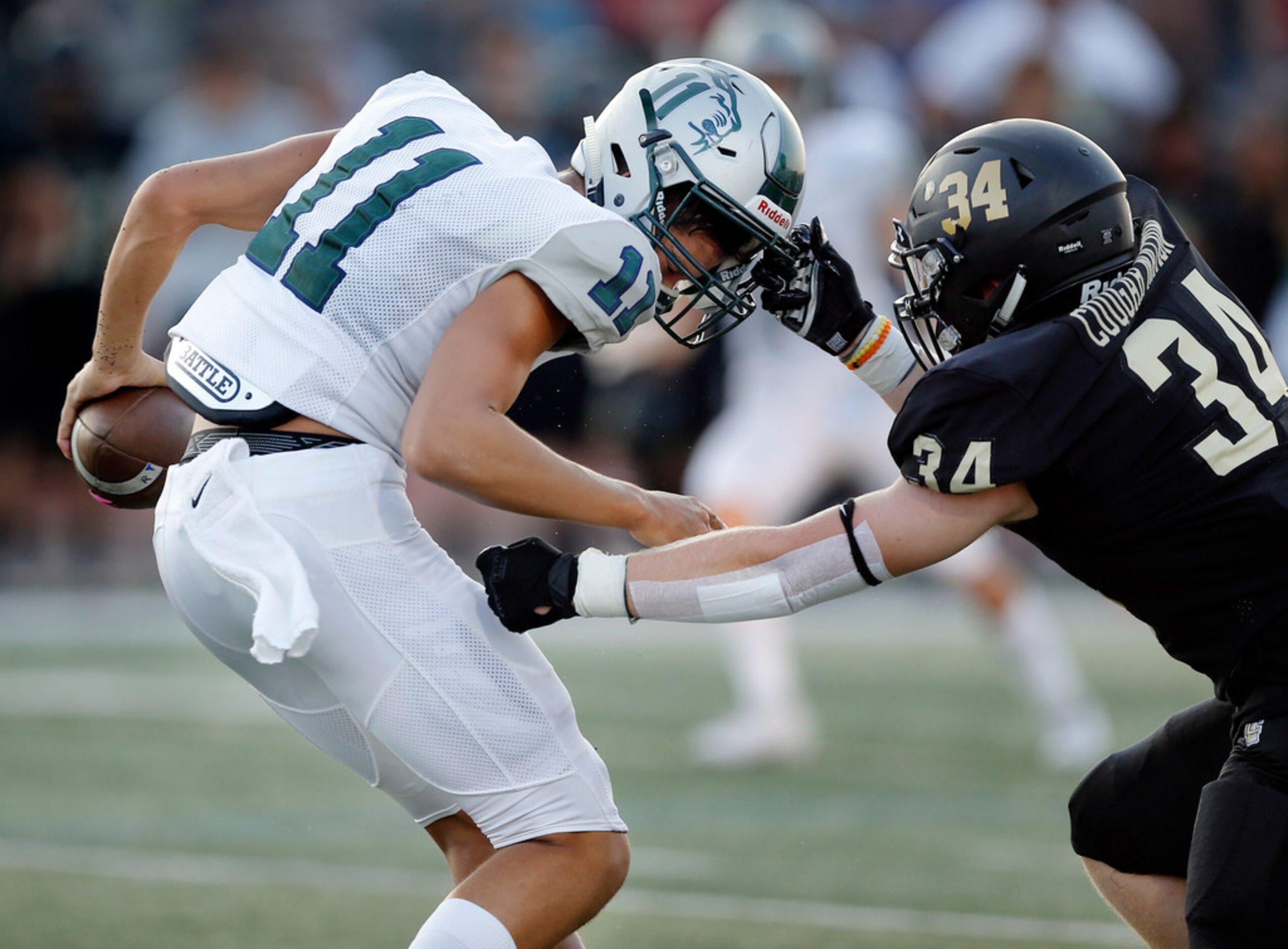 The Colony defensive end Stephen McCollom (34) pulls down Frisco Reedy quarterback Jalen...