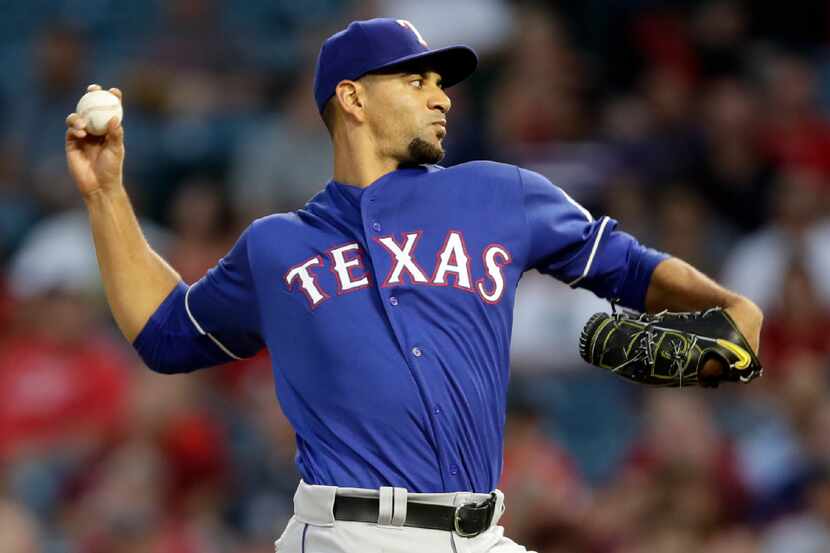 Texas Rangers starting pitcher Tyson Ross throws to the Los Angeles Angels during the first...