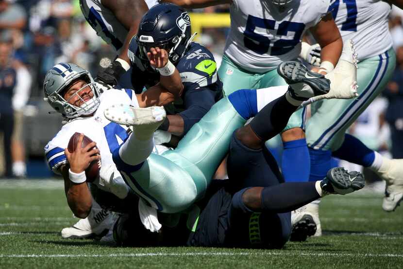 Dallas Cowboys quarterback Dak Prescott (4) is sacked by Seattle Seahawks defensive tackle...