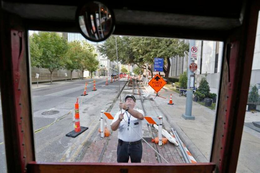 
M-Line Trolley motorman Leo Tresp switches the ends of the vehicle’s cable at the route’s...
