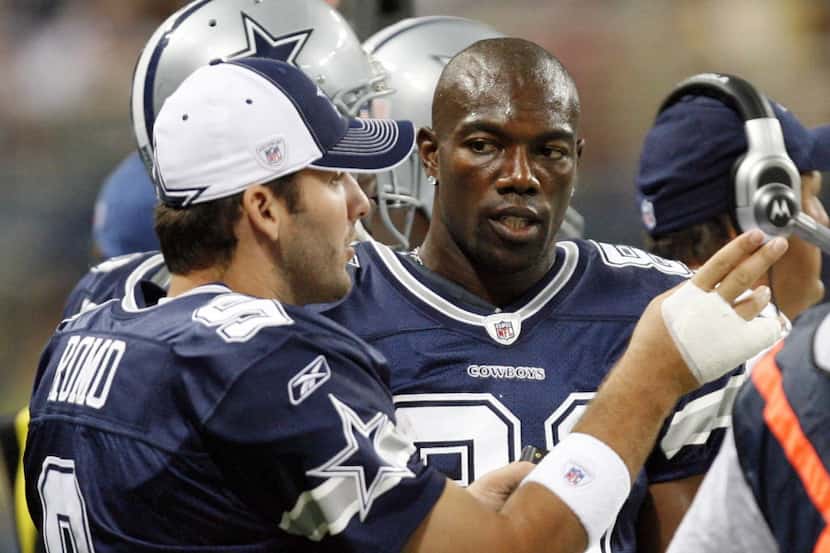 Dallas Cowboys Tony Romo (9) talks with Terrell Owens (81) on the sidelines in a game...