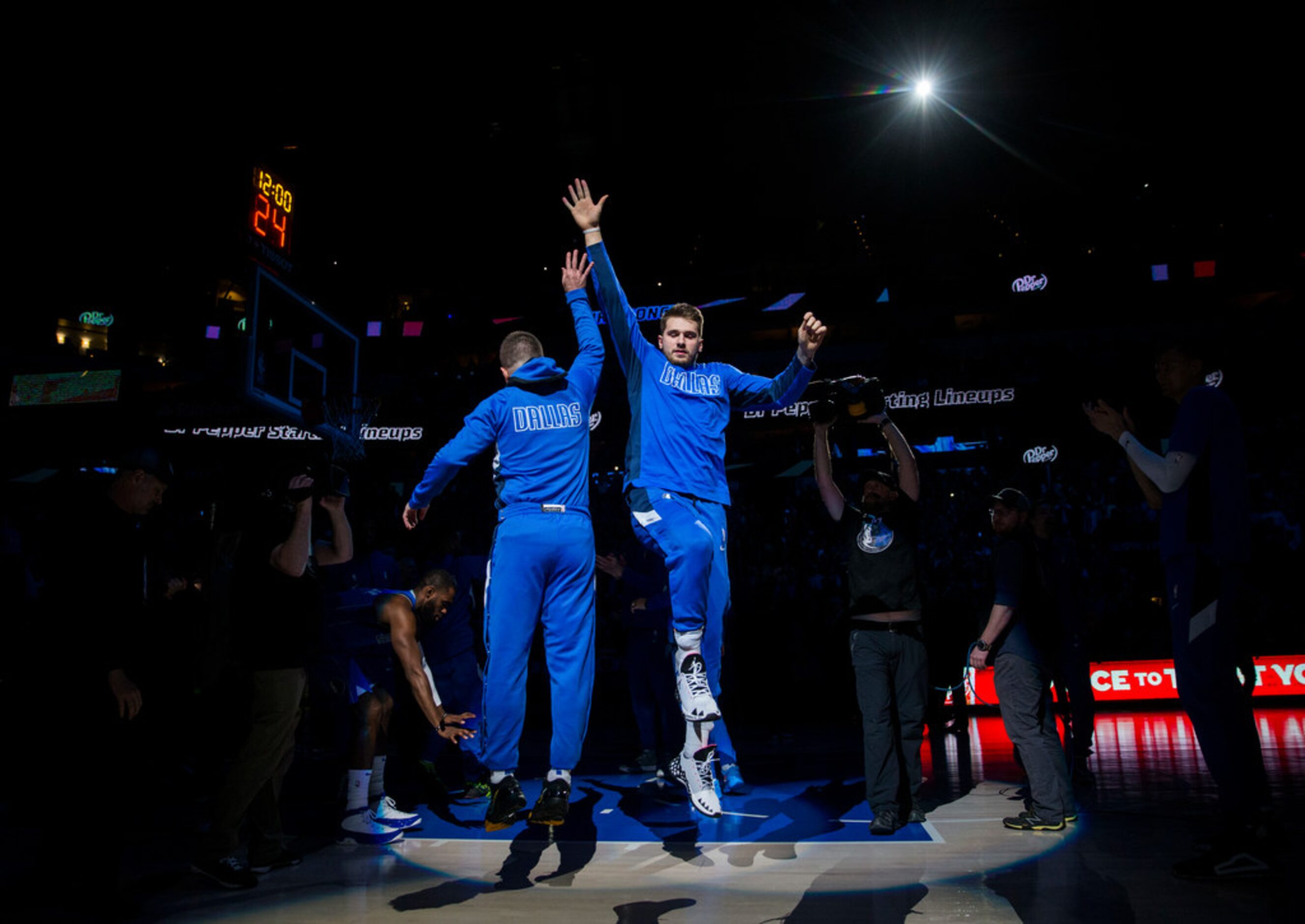 Dallas Mavericks guard Luka Doncic (77) high-fives guard J.J. Barea (5) as they are...