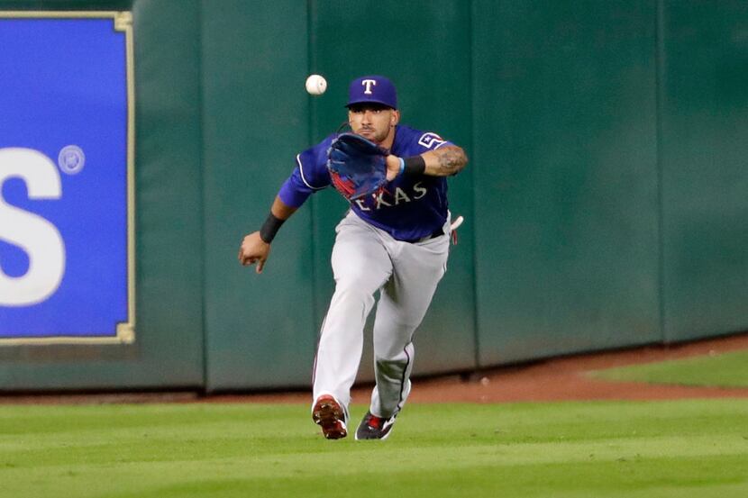 Texas Rangers center fielder Ian Desmond catches Houston Astros' Jose Altuve's fly ball for...