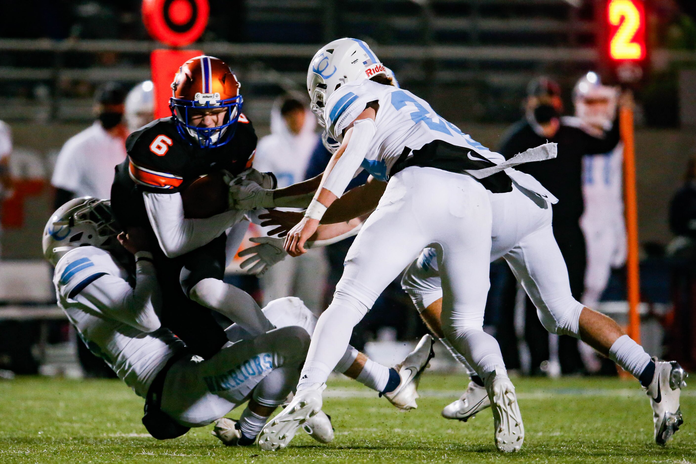 Colleyville Covenant's Caleb Turner (6) is tackled by the Cypress Christian defense during...