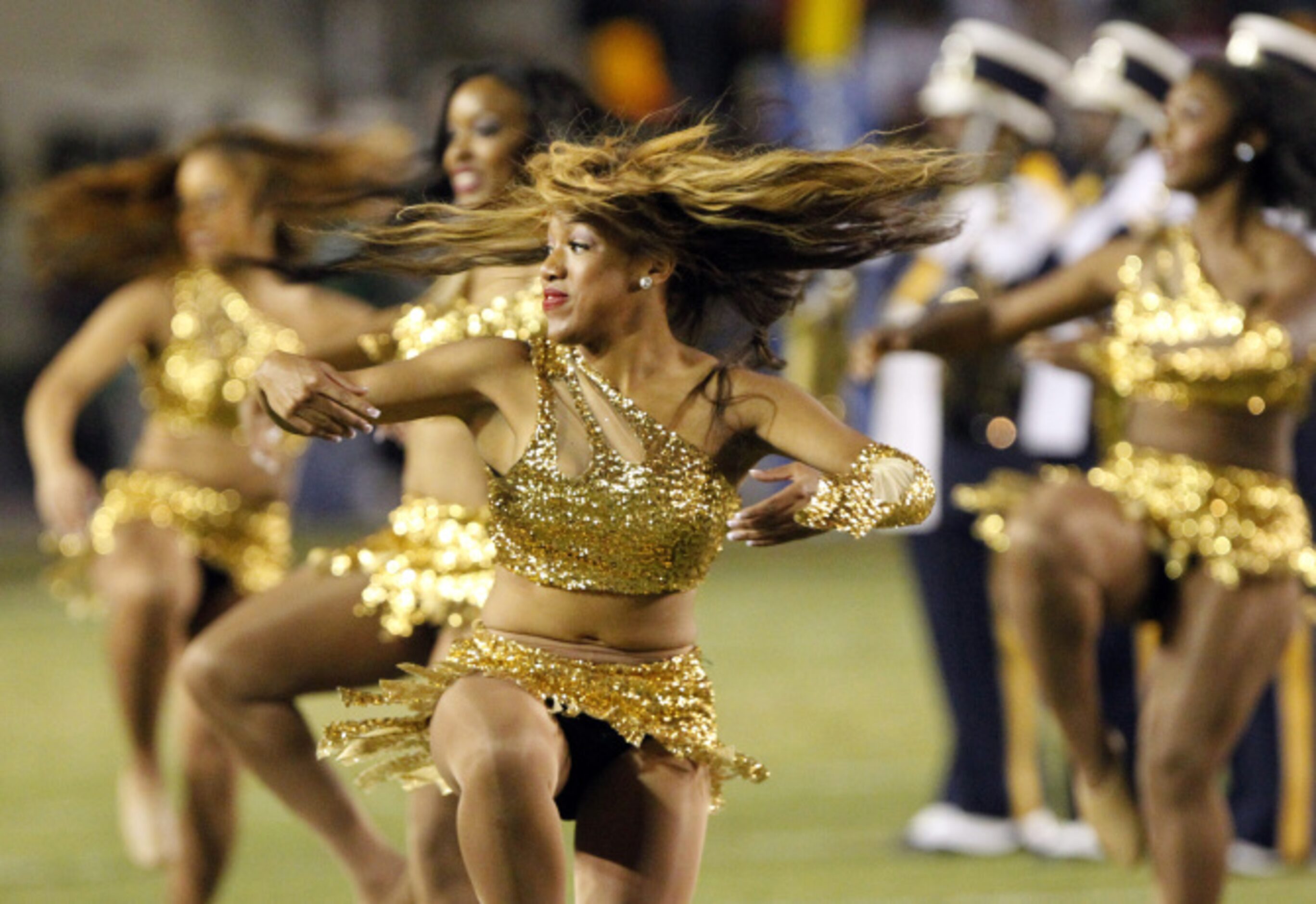 A Prairie View A&M dancer's hair swirls around her head during the halftime show of a NCAA...