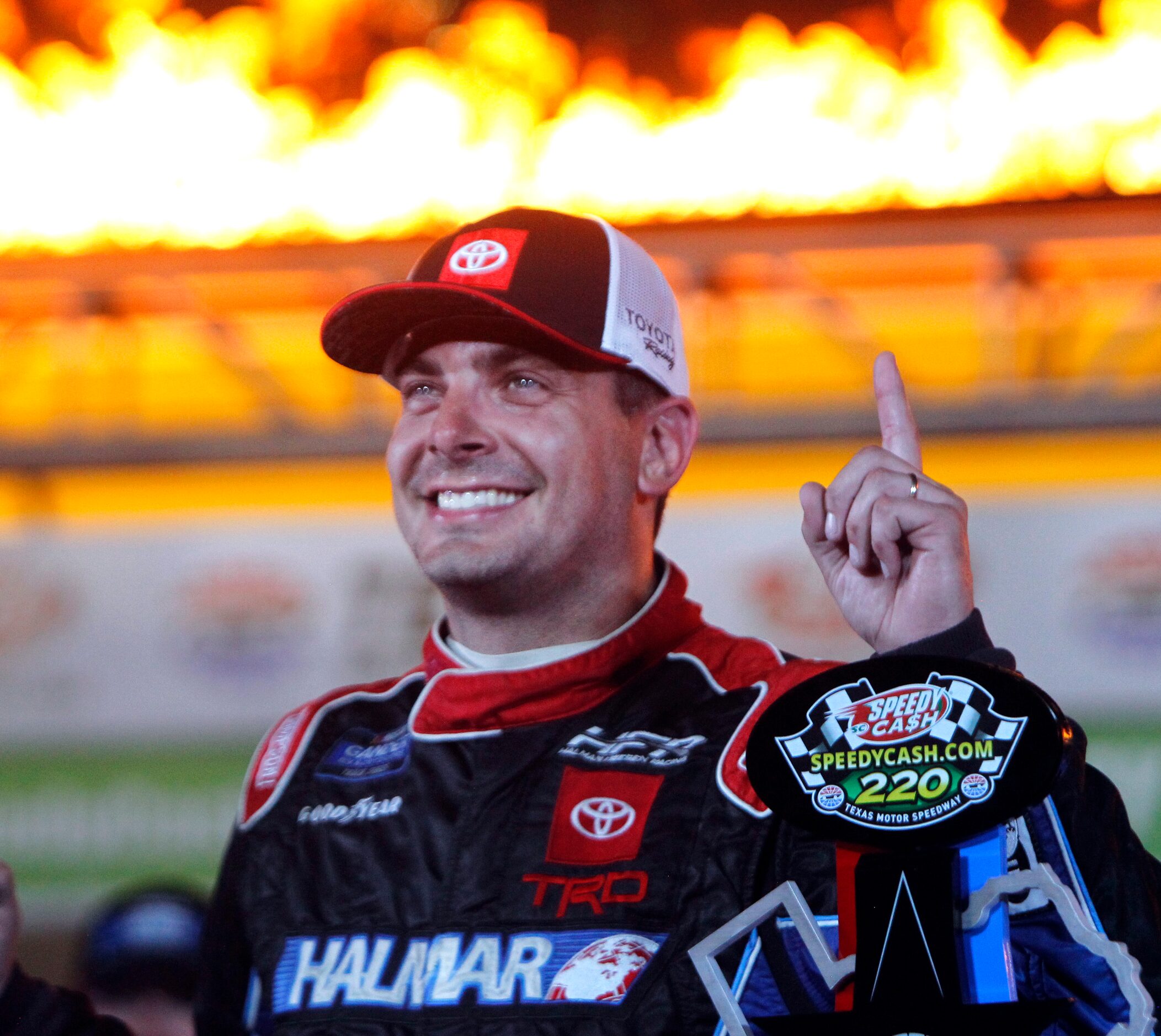 Stewart Friesen poses for photos after coming from behind in the final two laps to claim...