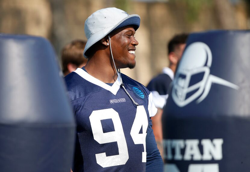 Dallas Cowboys defensive end Randy Gregory smiles during afternoon practice at the training...