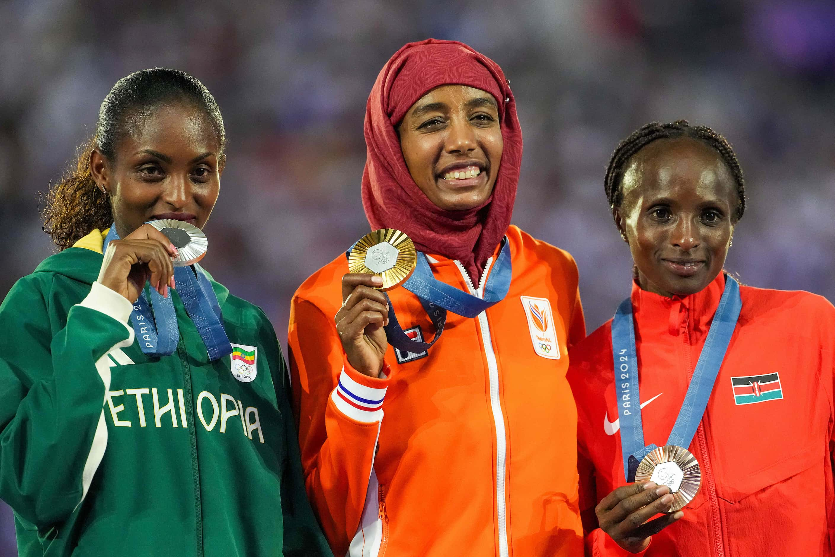 Women's marathon gold medalist Sifan Hassan of the Netherlands (center) poses with with...