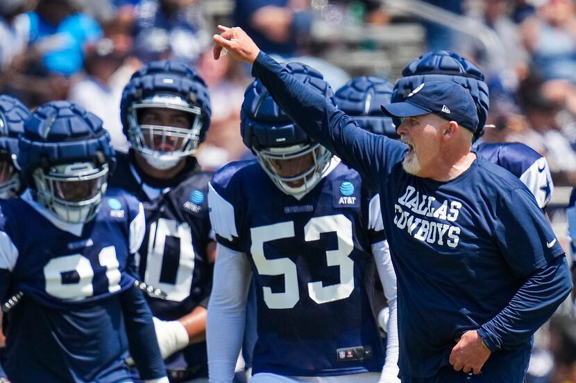 Dallas Cowboys defensive coordinator Dan Quinn directs players during a training camp...