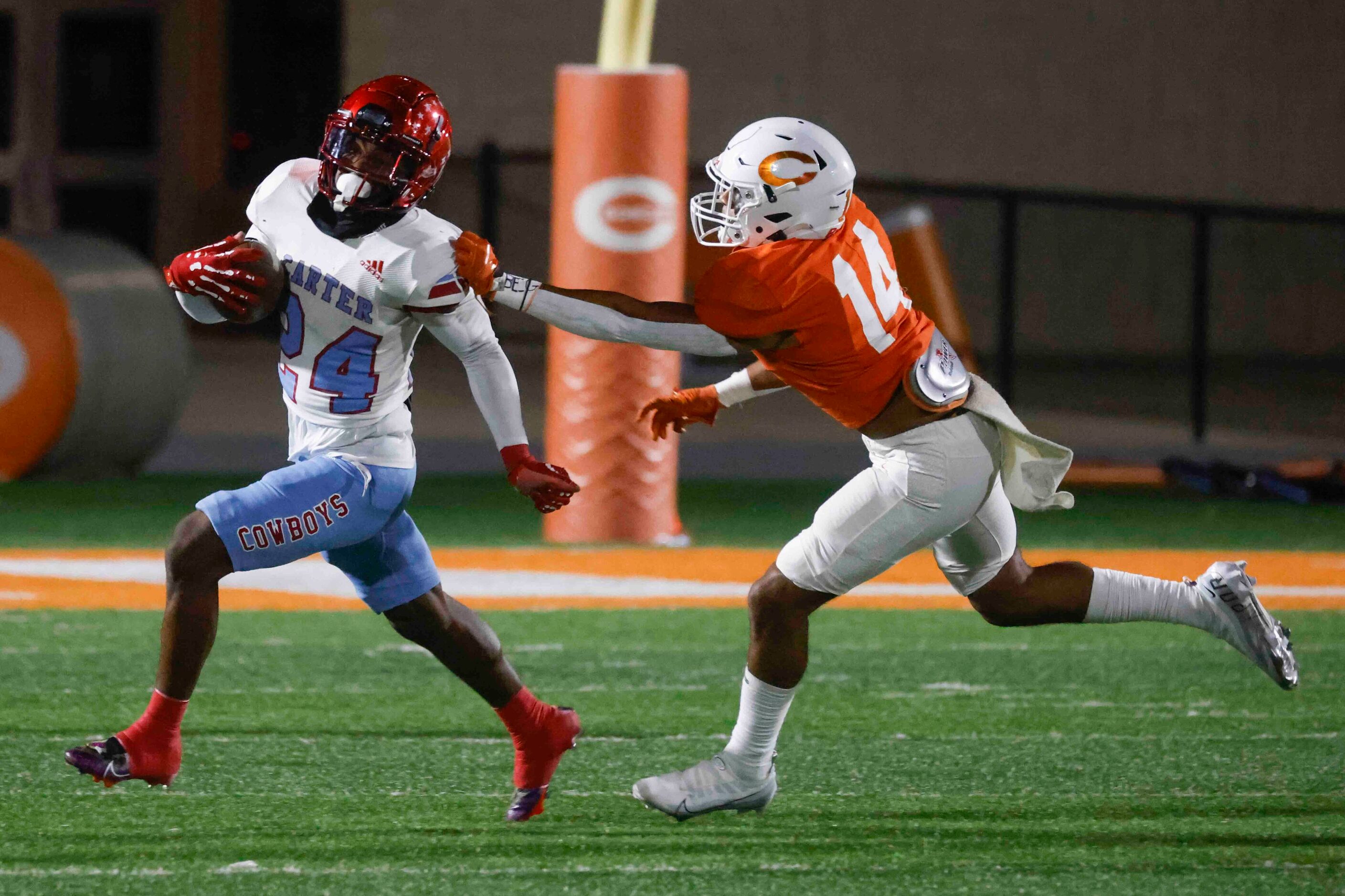 David W. Carter High School’s Kaeden Landry (24), left,  gets tackled by Celina High...