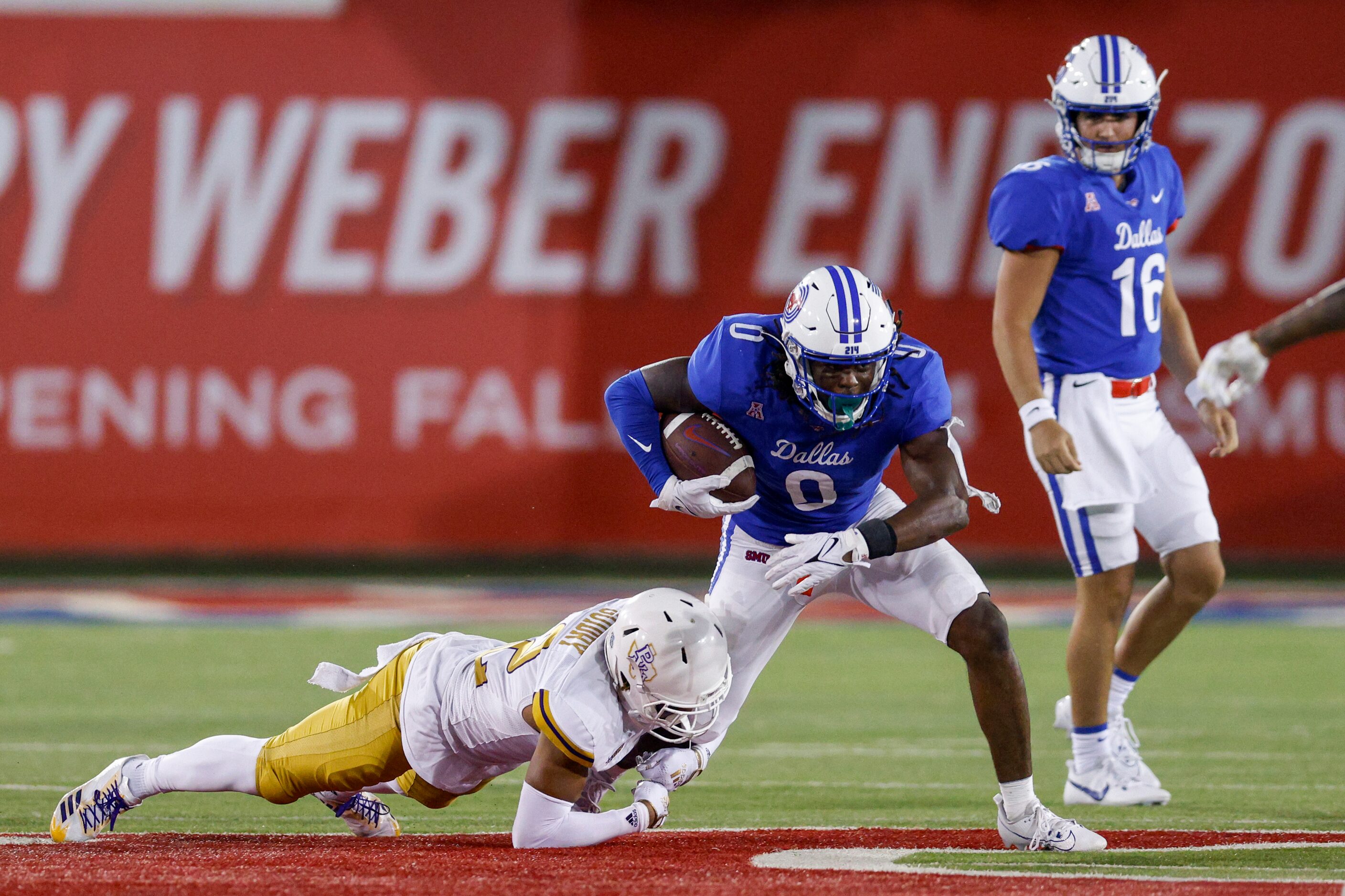 Prairie View A&M linebacker Tayvian Guidry (42) tackles SMU running back Camar Wheaton (0)...