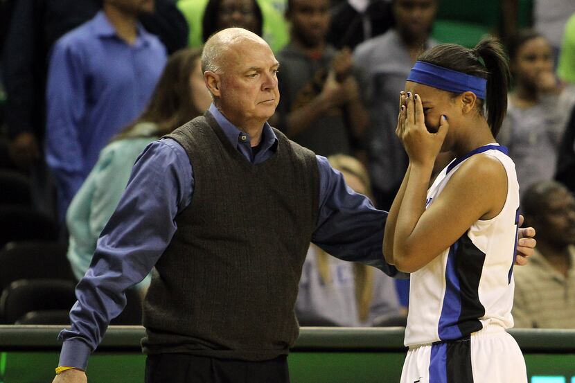 Plano West Wolves' g Devri Owens (13) is consoled by Plano West Wolves' head coach Don...