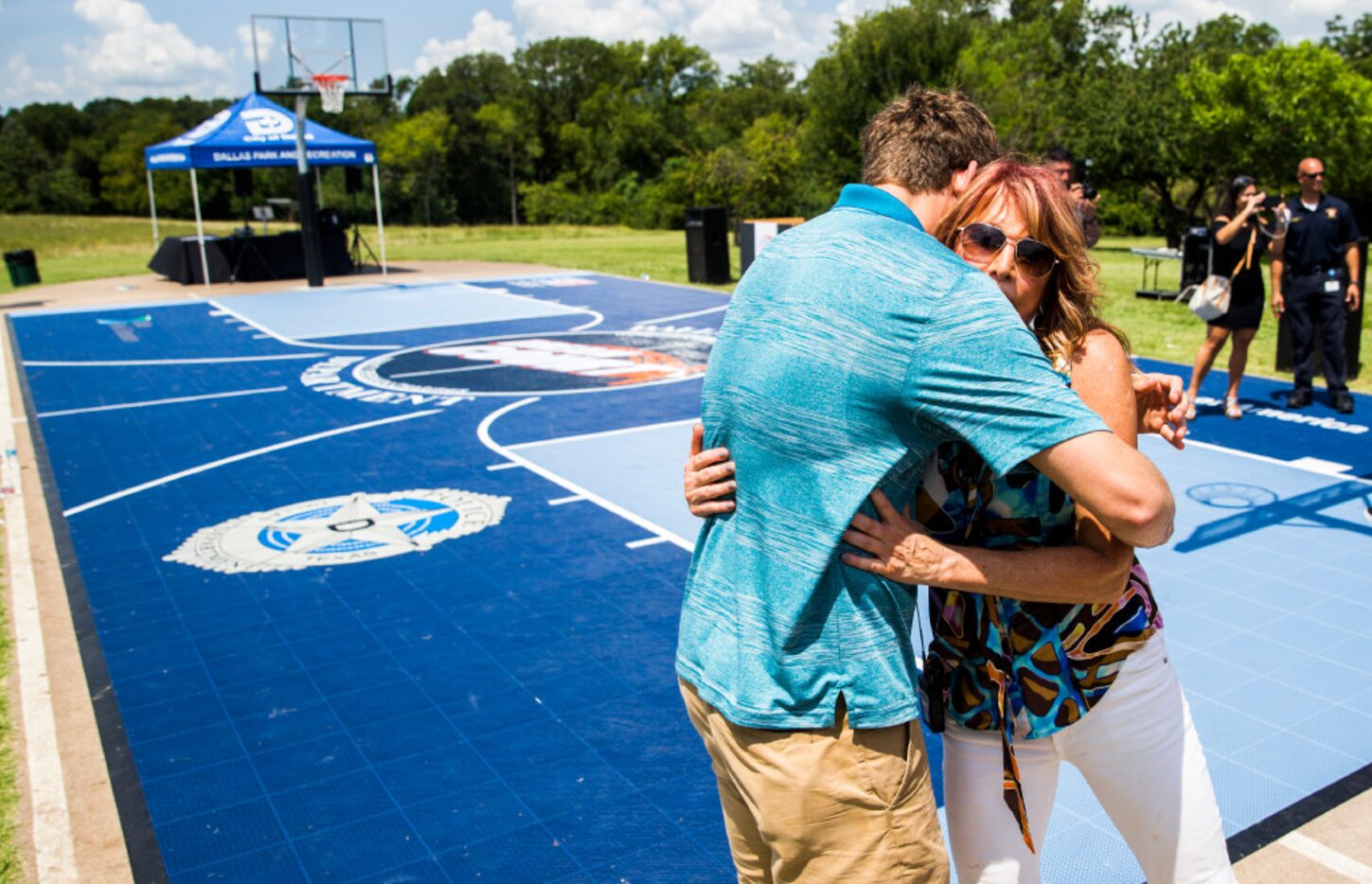 T.J. Cline (left) hugs his mother, women's basketball legend Nancy Lieberman, as the ribbons...