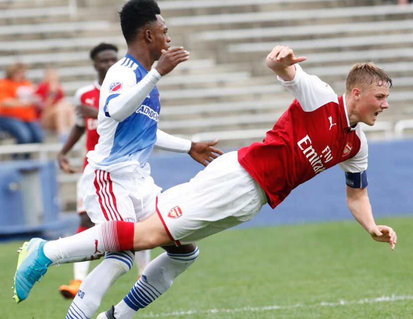 Arsenal FC's Daniel George Ballard (5) goes flying after a collision with Fc Dallas' Ronaldo...