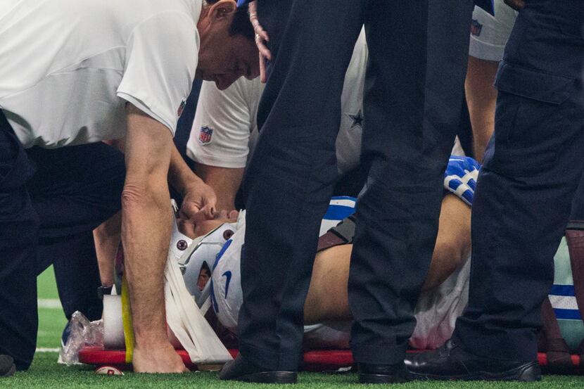 Dallas Cowboys defensive tackle Tyrone Crawford (98) is checked out after an injury during...