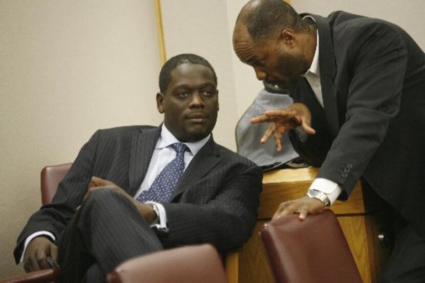 Then-Dallas County District Attorney Craig Watkins talks with prosecutor Gordon Hikel in the...