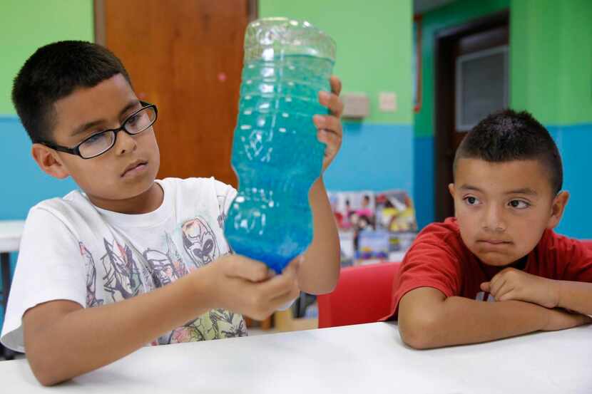 
Julio Covarrubias (left), 10, and Cruz Zarate, 8, took part in a lava lamp experiment at...