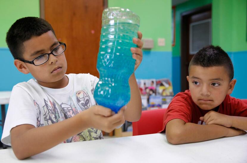 
Julio Covarrubias (left), 10, and Cruz Zarate, 8, took part in a lava lamp experiment at...