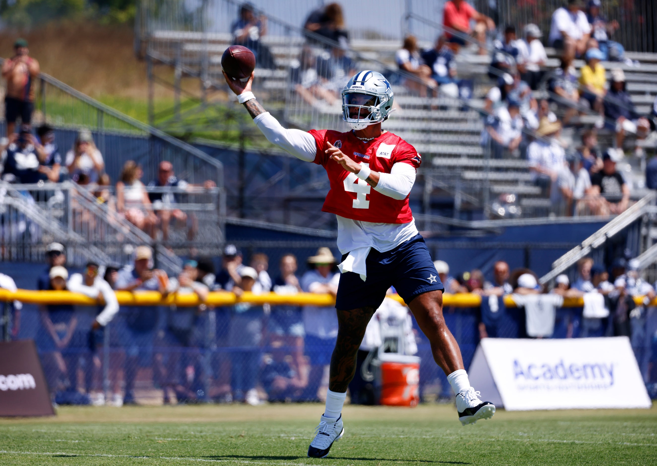 Dallas Cowboys quarterback Dak Prescott (4) throws on the run during a training camp...