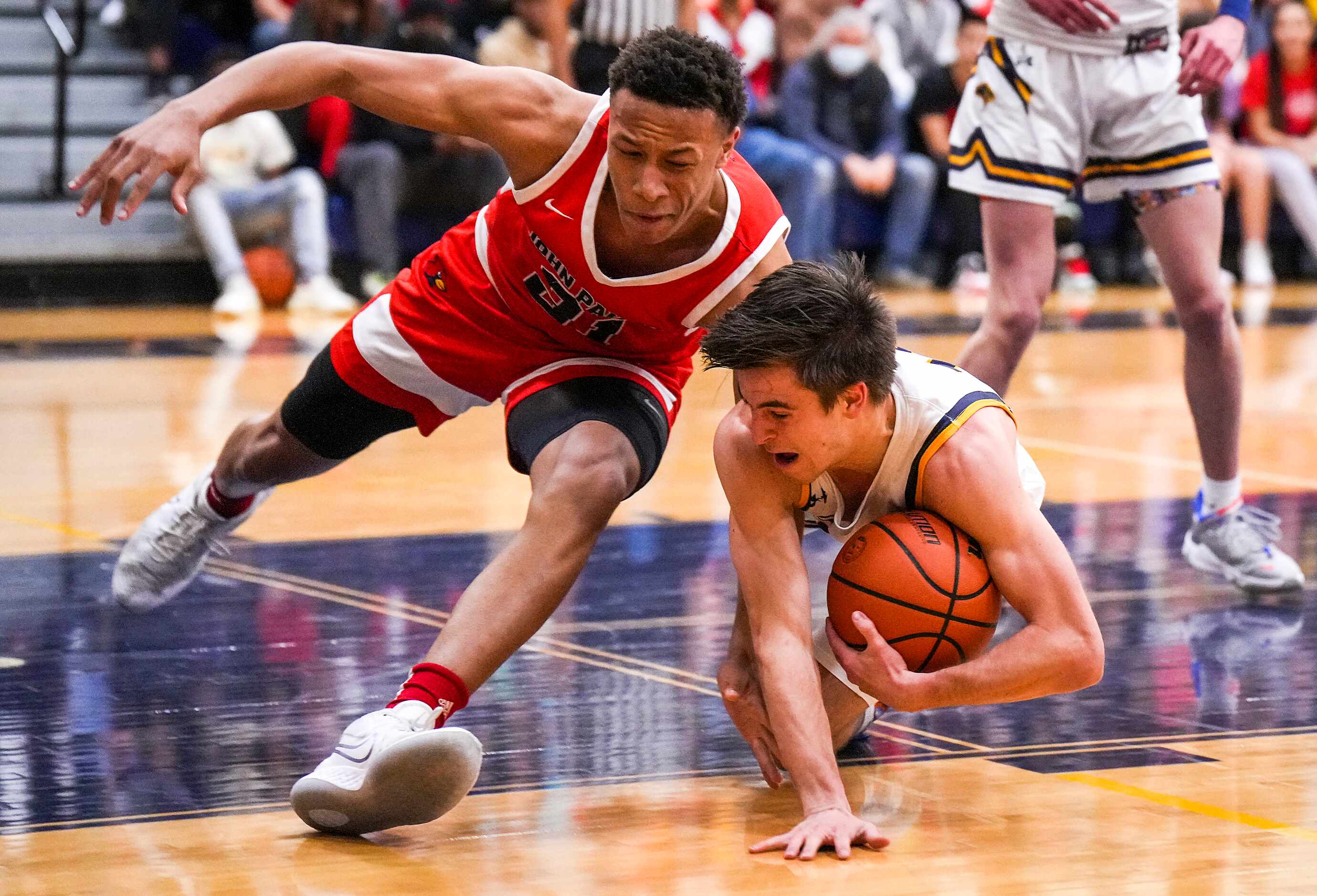 John Paul II's Gabe Warren (21) fights for a loose ball with Prestonwood Christian's Jake...