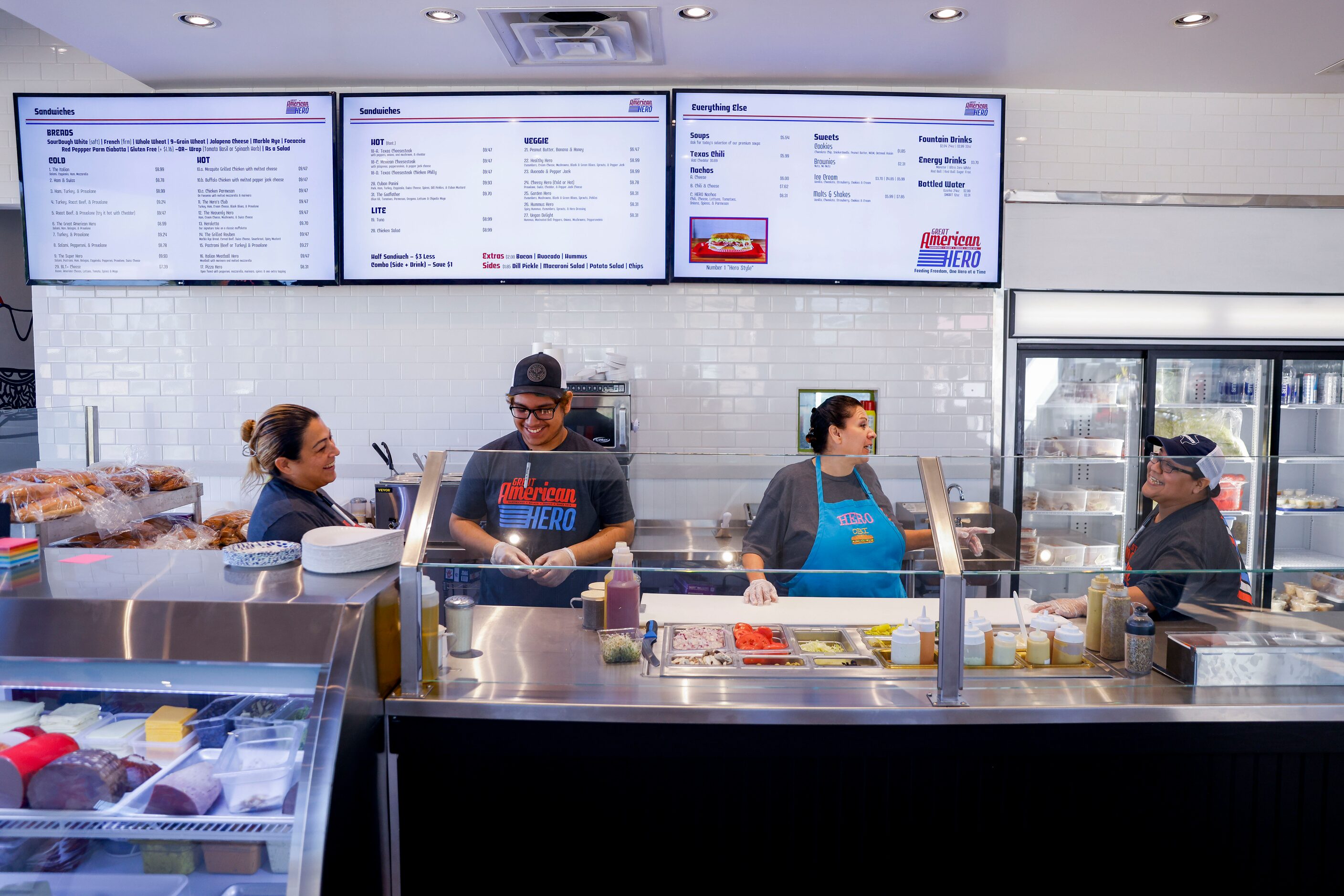 Workers chat in-between orders on Wednesday, Sept. 21, 2022, at Great American Hero’s new...