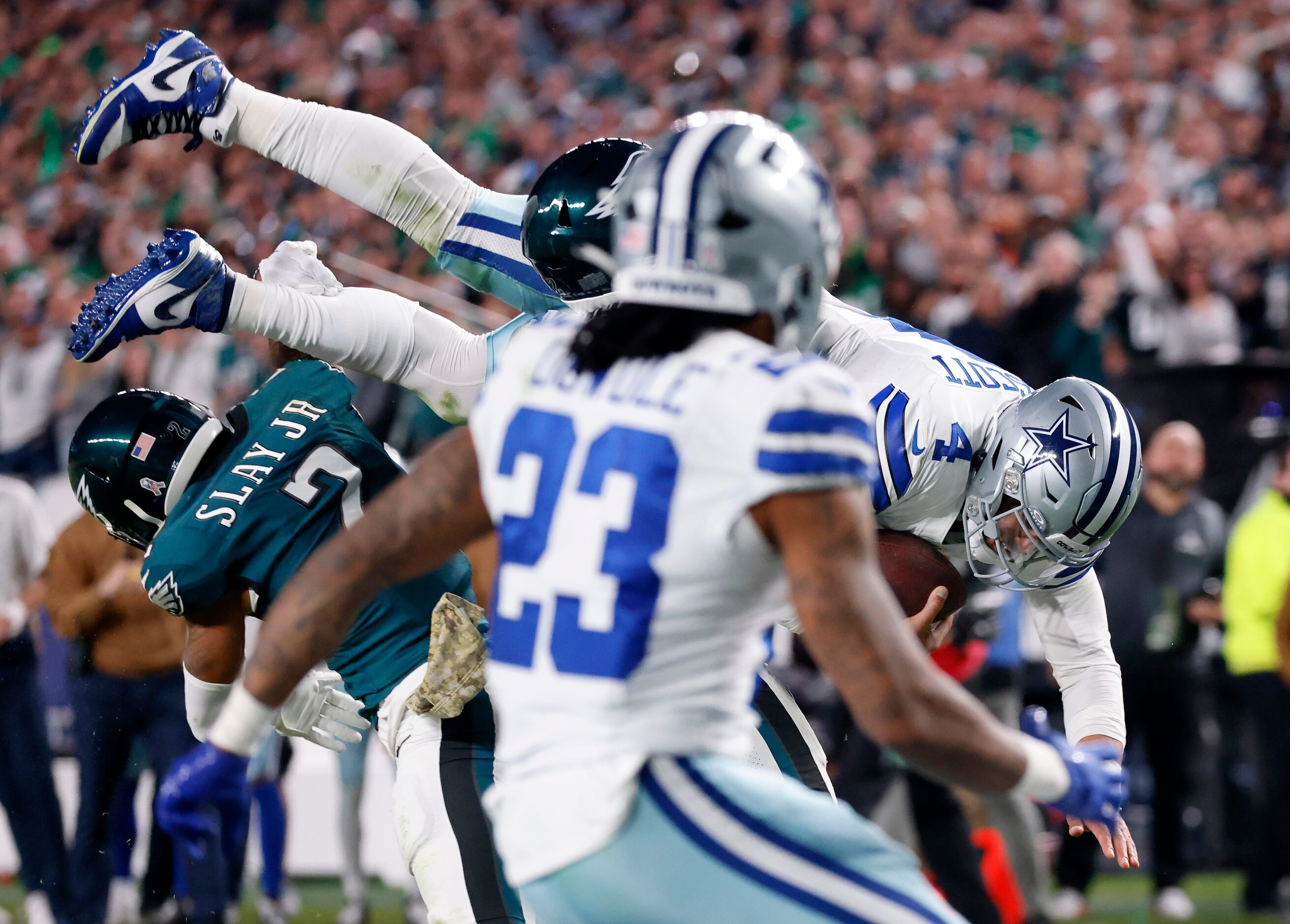 Dallas Cowboys quarterback Dak Prescott (4) is flipped by Philadelphia Eagles cornerback...