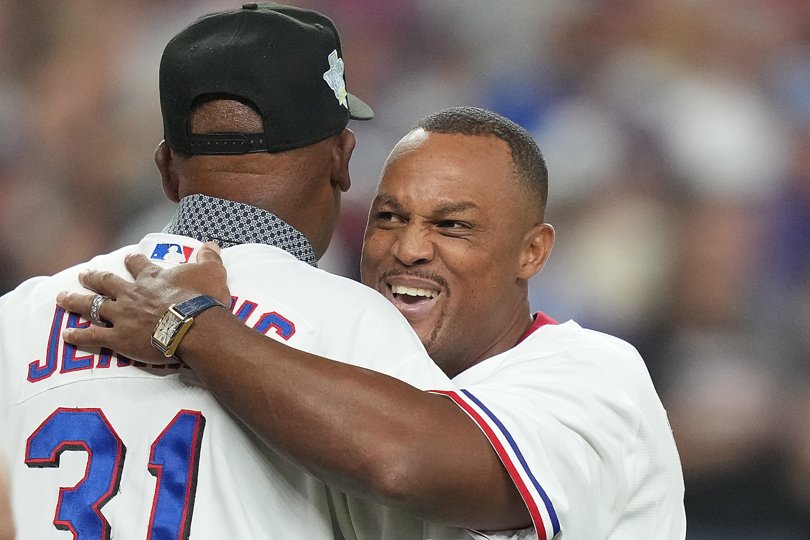 Former Texas Rangers pitcher Fergie Jenkins embraces former third baseman Adrián Beltré...