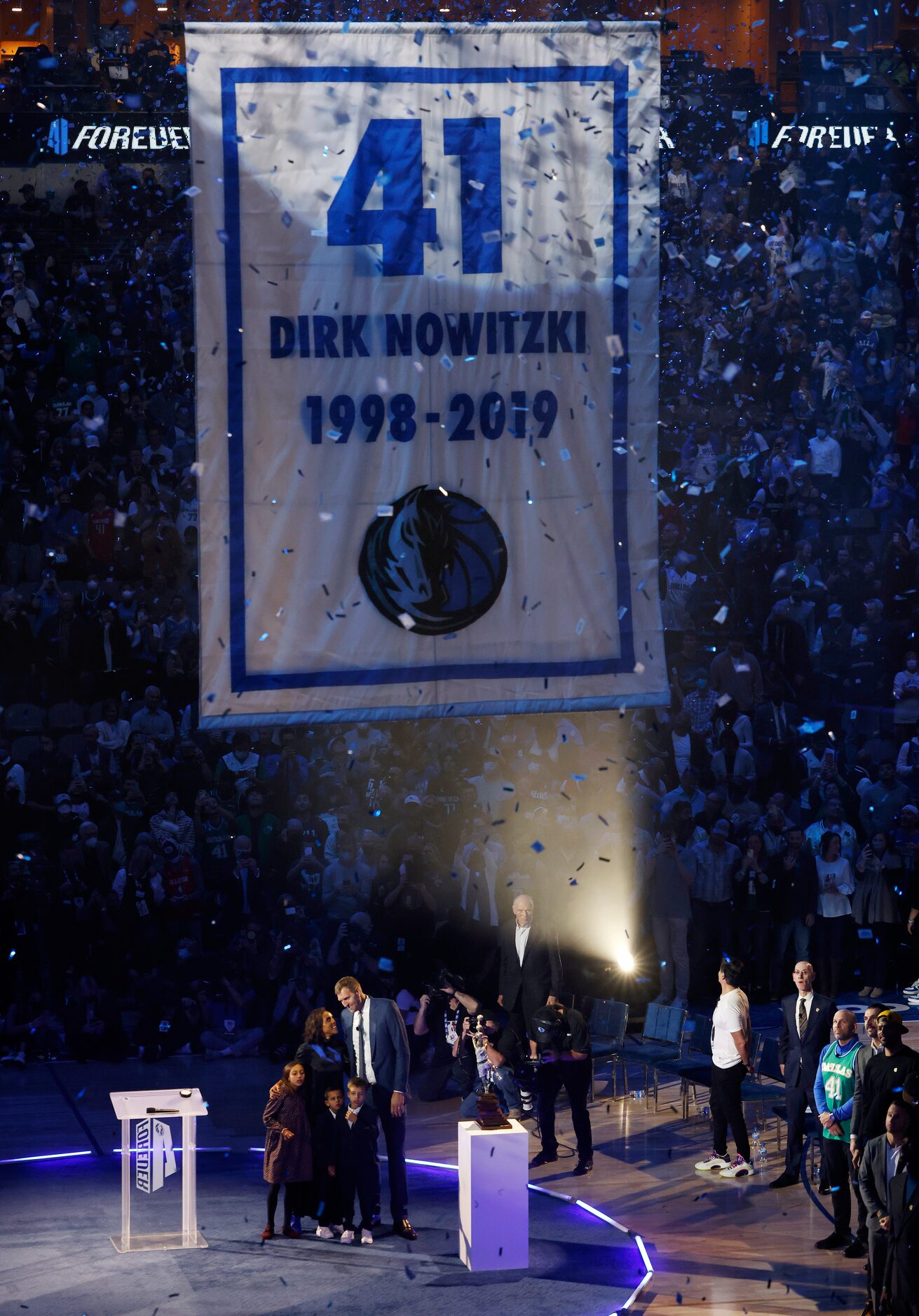 Former Dallas Mavericks player Dirk Nowitzki with his wife Jessica and kids watch as his...