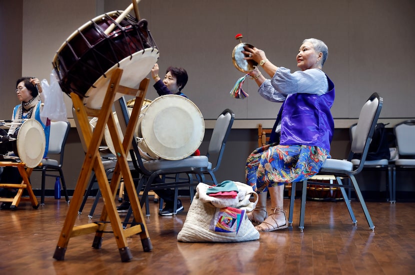 Kyong Cooper plays a kkwaenggwari as the Arirang Texas Group practices together. 