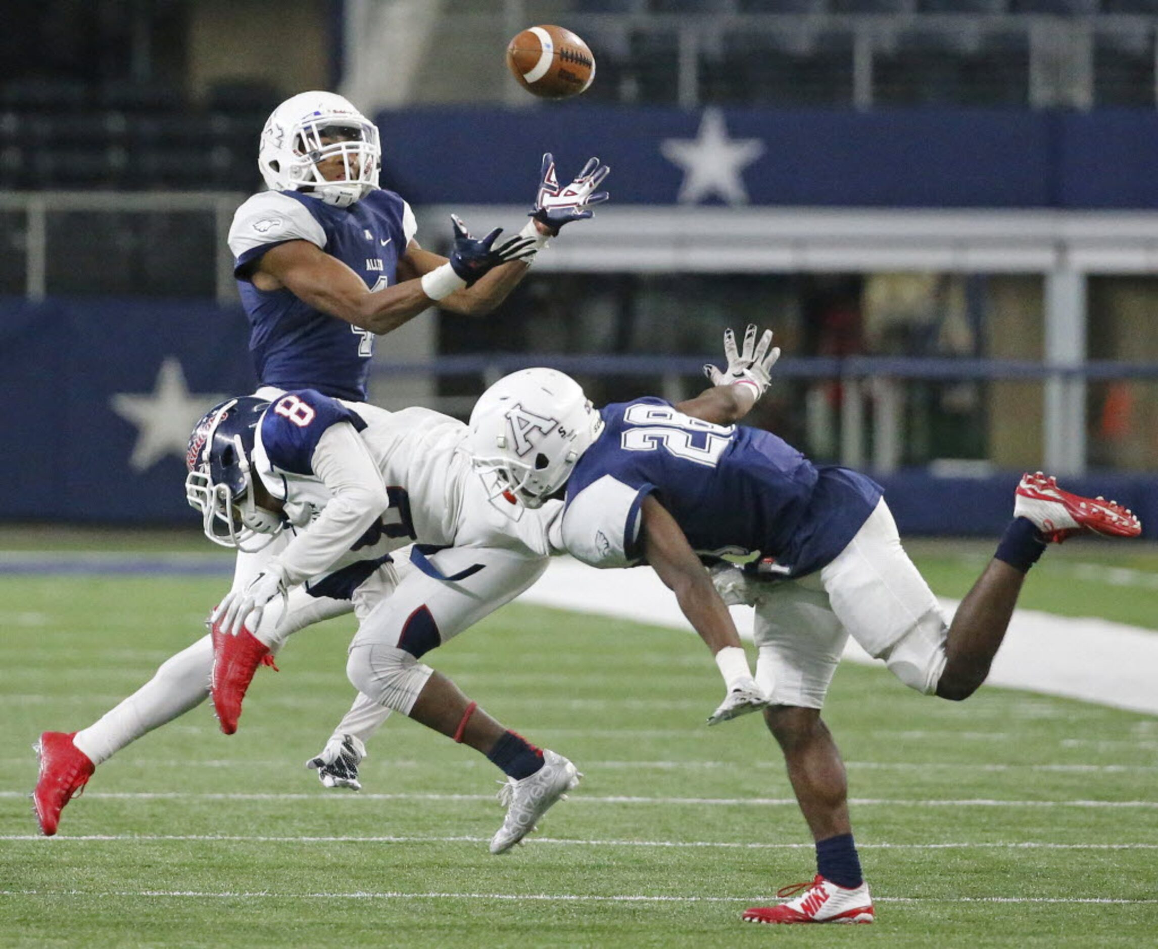 Allen defenders Jaylon Jones, left, and Nick Allen (28) break up a pass intended for Ryan's...