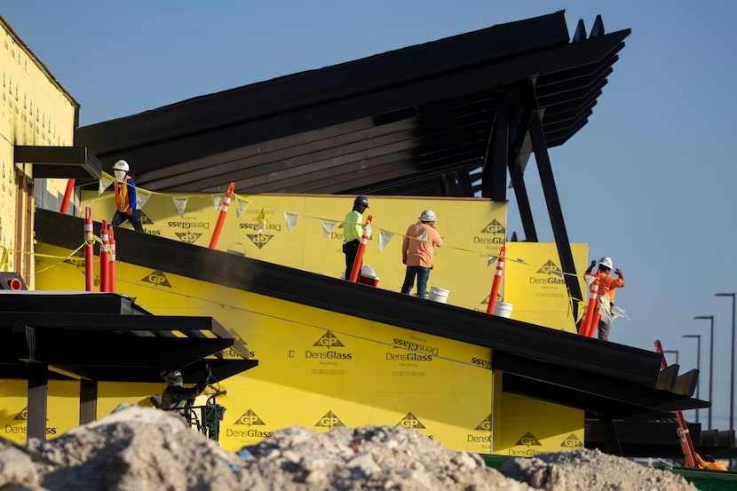 Construction workers on the roof of the new H-E-B in Plano. It's scheduled to open this fall. 