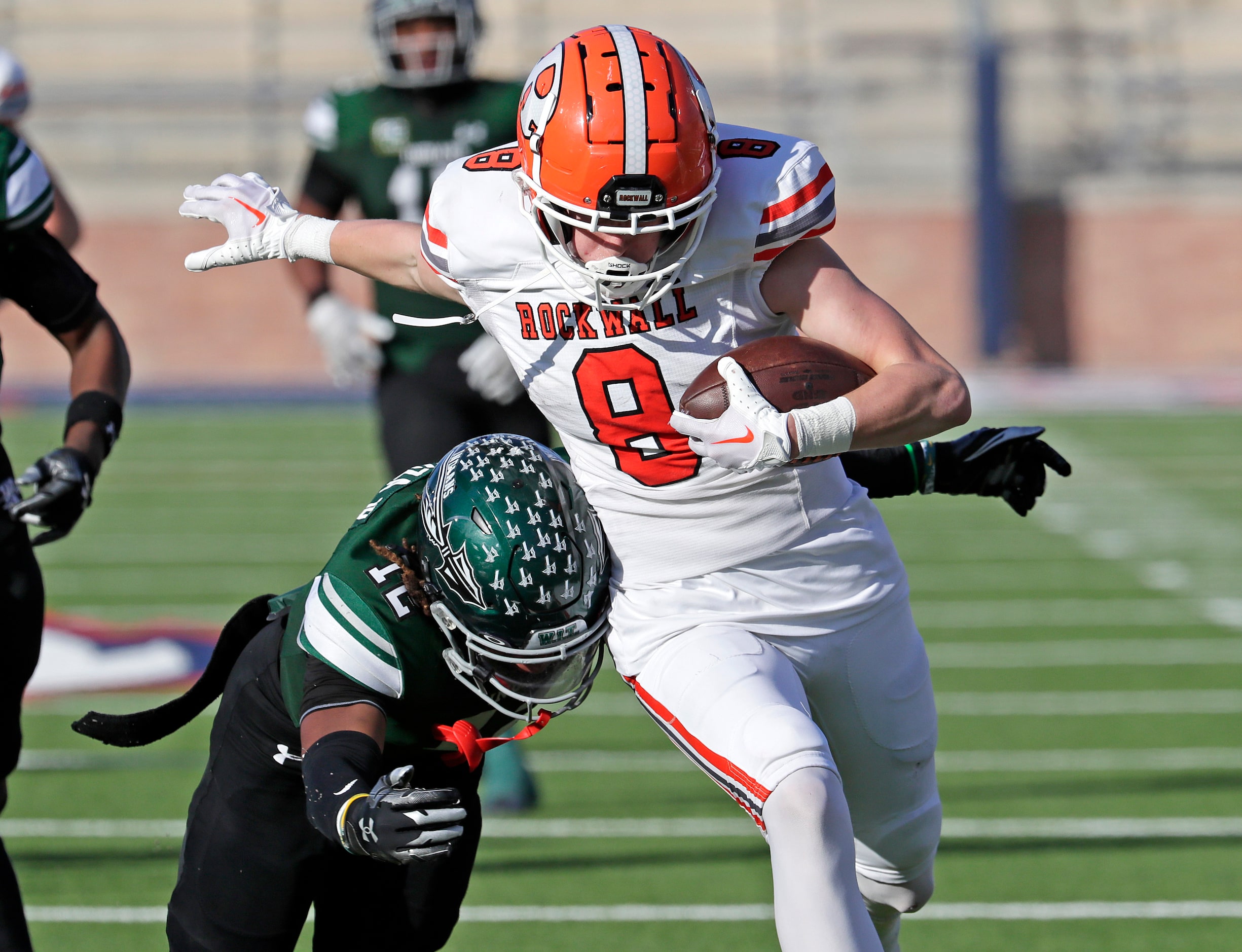 Rockwall High School wide receiver Tristan Gooch (8) is caught by Waxahachie High School...